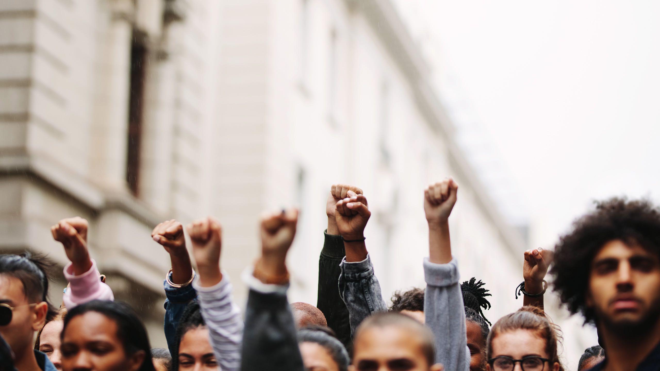 Arms raised in protest.