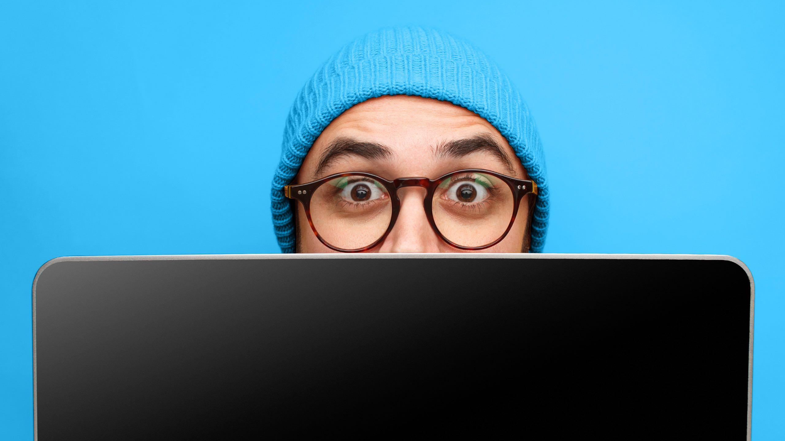 Man behind laptop screen.